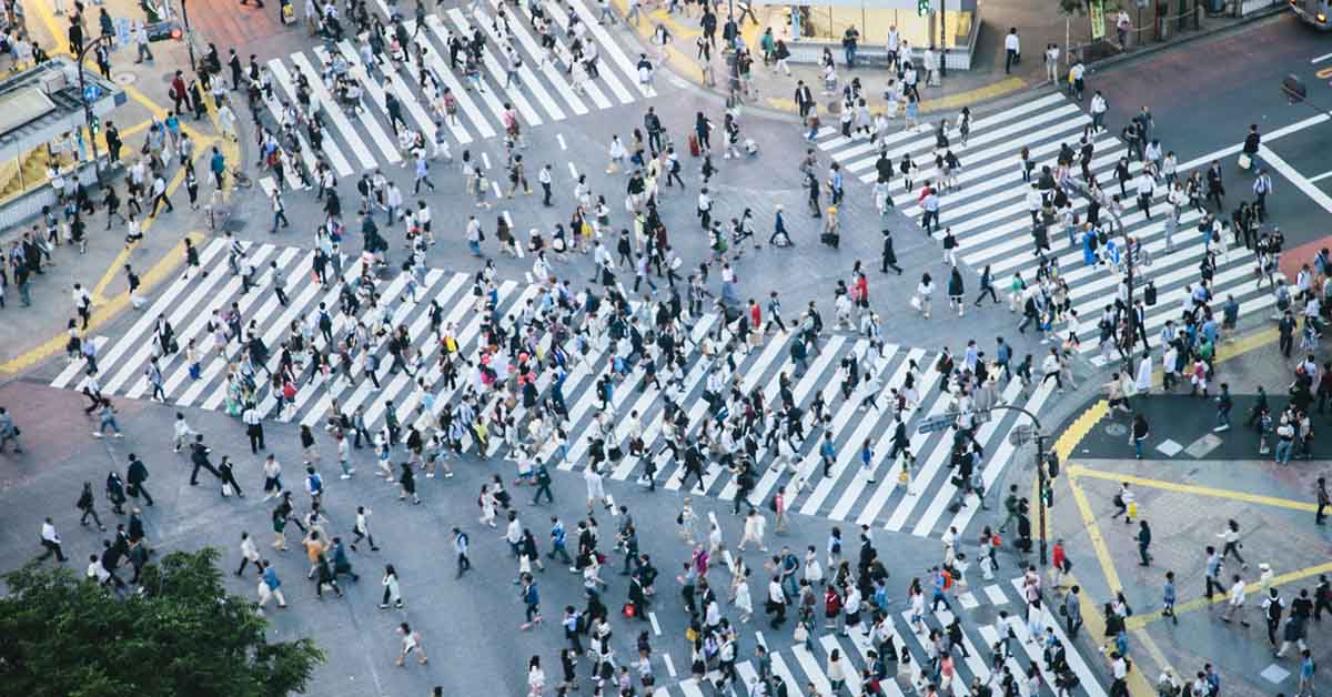 Overhead view of pedestrians crossing the famous Shibuya intersection in Tokyo