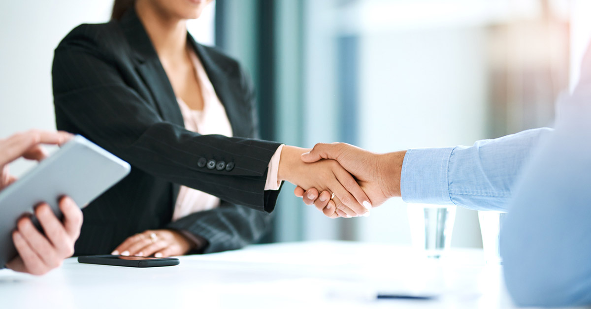 A handshake between a company's hiring manager and an RPO representative