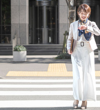 Japanese Business Woman Leaving Work With A Smile While Looking At Her Watch (1)